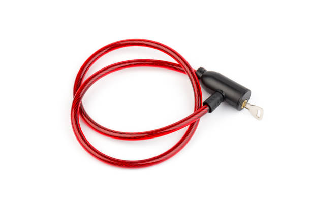 istock Flexible red bicycle cable with key on white background.  Security and safety concept. 1286117419