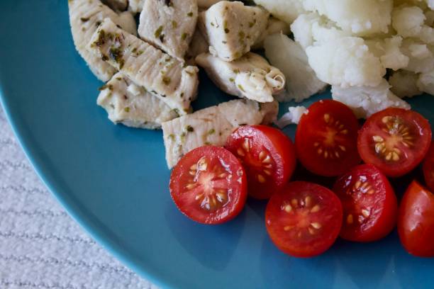 Healthy dish made of cherries, chicken and cauliflower