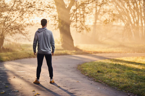 istock Athletic runner standing in park at autumn or winter morning 1286120169