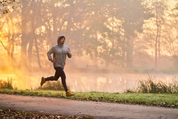istock Man jogging in the park during autumn morning 1286120637