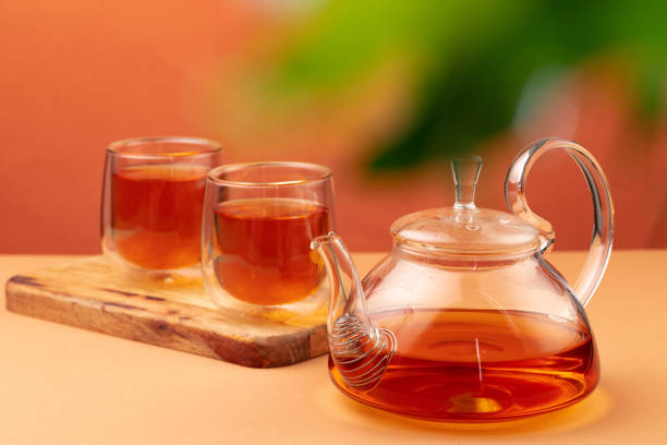istock Glass teapot and two glass cups with tea 1286122338