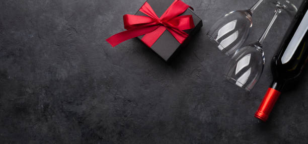 istock Valentines or Christmas card with wine and gift 1286123875