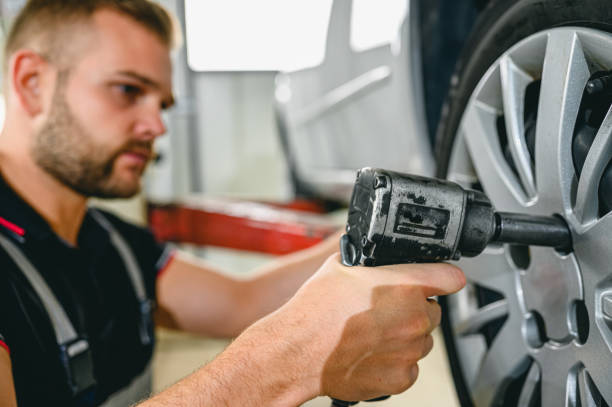 istock Car mechanic is changing tire 1286124963