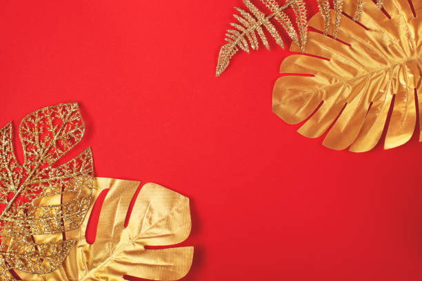istock Golden leaves on bright red background. 1286126220