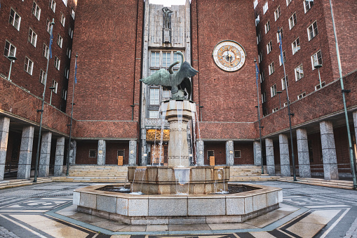 Exterior of the Oslo City Hall (Radhuset) entrance and fountain in Oslo, Norway. Building hosting Nobel peace prize