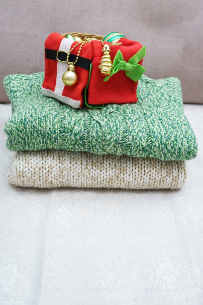 istock a stack of warm knitted clothes and Christmas decorations 1286127831