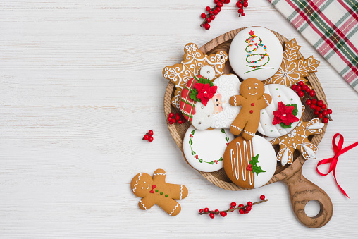 Christmas homemade gingerbread cookies on wooden plate with copy space