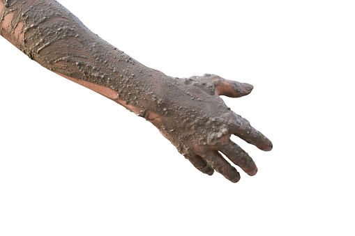 Hand covered with mud isolated on white background with clipping path.