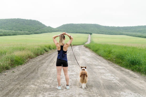 istock Young woman ready for workout outside with dog 1286129639