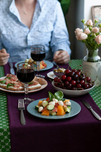 istock A gourmet lunch for two: a salad, fresh cherries and various appetizers. 1286129975