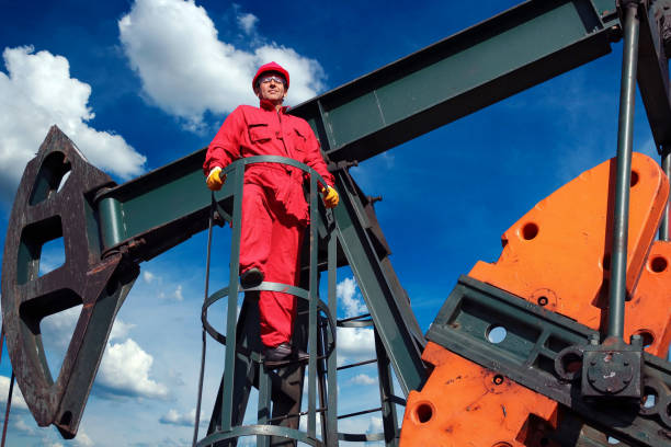 istock Oil Worker and Petroleum Industry Pump Jack 1286131039