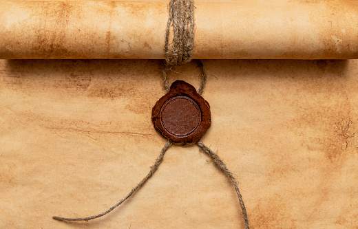 An old paper scroll sealed with a wax seal. The manuscript is rolled up and sealed.