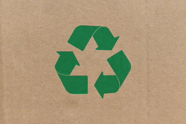 istock Green recycle symbol on cardboard background. 1286133145