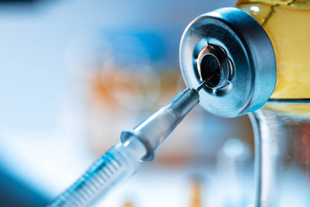 istock Vaccine bottle with a syringe taking the vaccine from it 1286133575