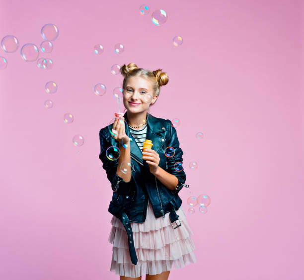istock Cheerful teenege girl blowing bubbles 1286133832