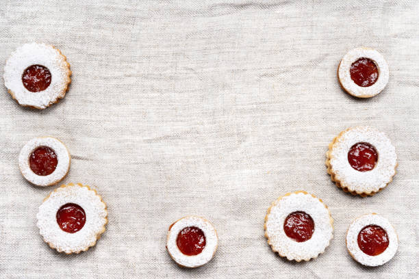 istock Christmas linzer cookies on light wrinkled tablecloth 1286134869