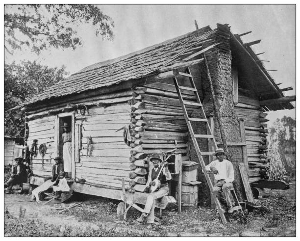 Antique black and white photo of the United States: Southern USA family Antique black and white photo of the United States: Southern USA family log cabin photos stock illustrations