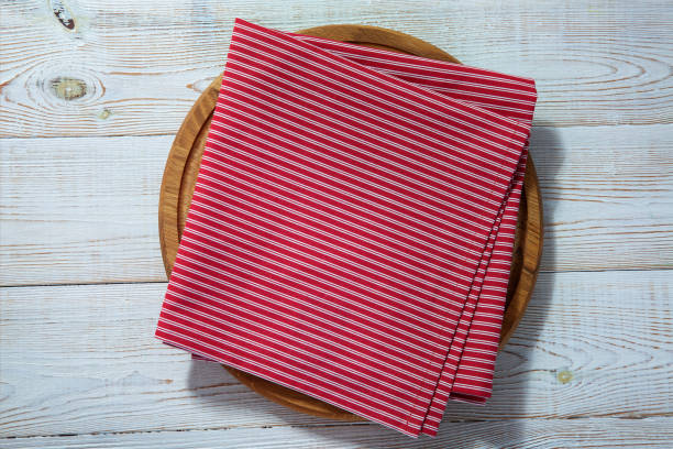 istock Empty pizza board and red napkin on white wooden 1286136092