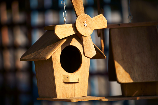 close up of handmade small windmill wooden birdhouse