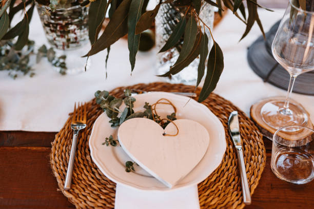 istock Lovely Boho Wedding Table Decoration with wooden heart on the plate 1286137721