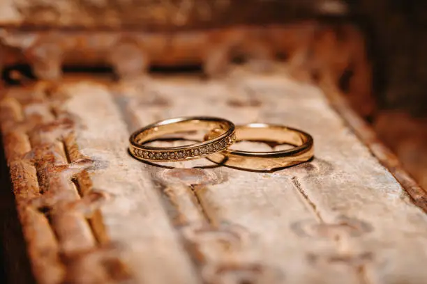 Photo of Wedding rings on a rusty and rustic background