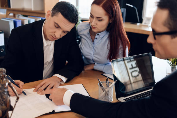 istock Divorce attorney shows man where to sign marriage dissolution agreement. 1286138091