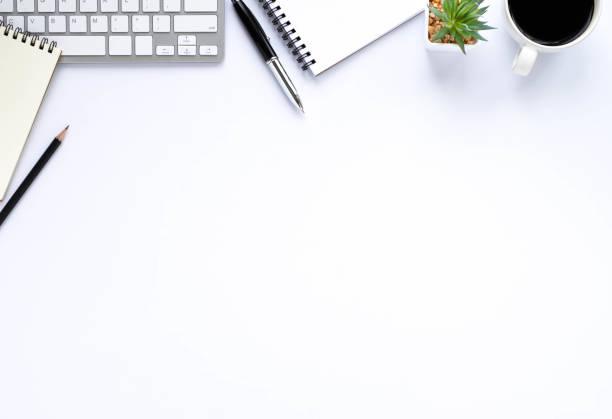 istock Top view above of White office desk table with keyboard, notebook and coffee cup with equipment other office supplies. Business and finance concept. Workplace, Flat lay with blank copy space. 1286139618