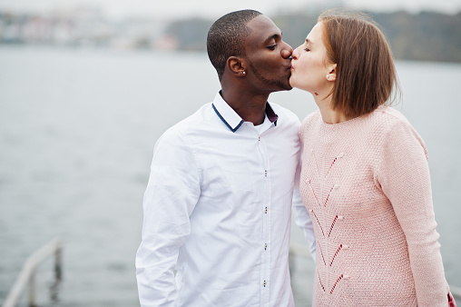 Happy multiethnic couple in love story. Relationships of african man and white european woman.