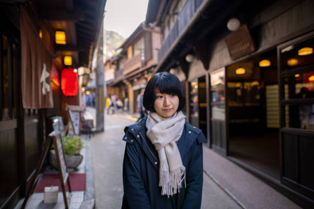 istock Young woman visiting Japanese local 'Onsen' (hot spring) district 1286140802