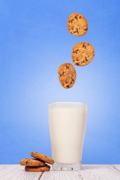 istock Chocolate chip cookies splasing into milk 1286140957