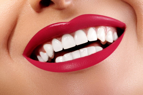 sorriso felice ravvicinato con denti bianchi sani, make-up labbra rosse brillanti. cosmetologia, odontoiatria e cura della bellezza - lifestyles toothy smile care beauty foto e immagini stock