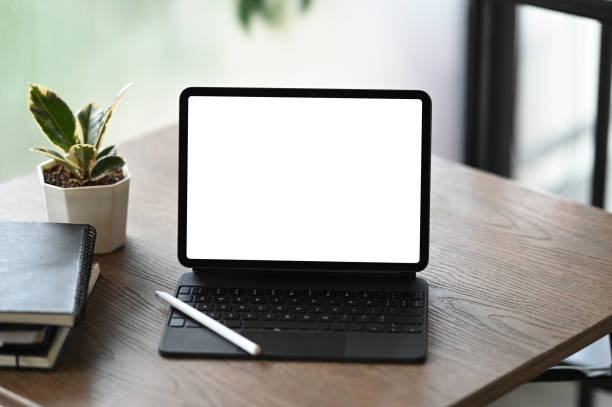 istock Mockup image of blank screen tablet computer, notebooks and houseplant. Blank screen for graphics display montage. 1286143007