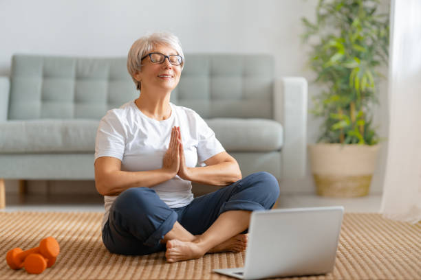 istock senior woman doing yoga 1286144633