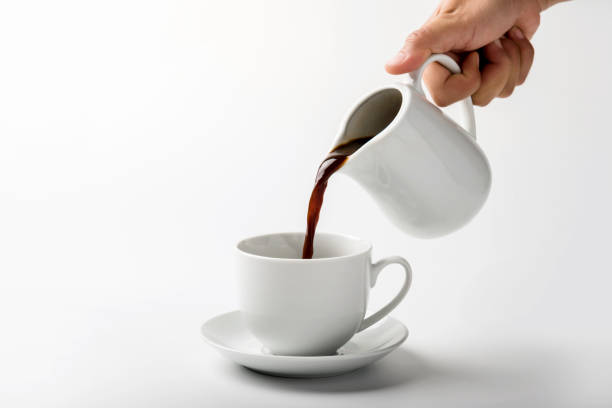 istock pouring a cup of coffee over white background 1286145735