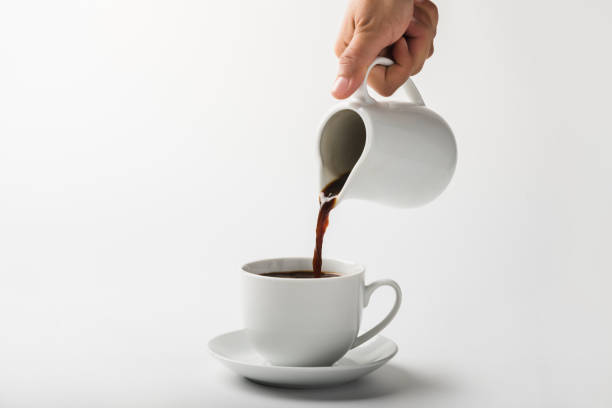istock Pouring coffee on a cup isolated on white background 1286145777