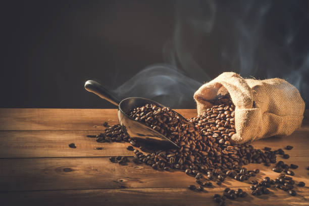 istock Coffee cup and Coffee beans spread on the table wooden old with copys for your text 1286145981