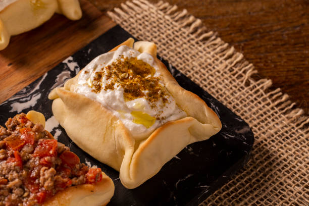 istock Varieties of Arabic sfihas open on rustic background. Meat, dry curd and endive. 1286146521