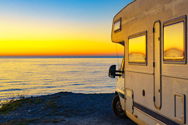 istock Rv camper camping on sea shore, Spain. 1286148438