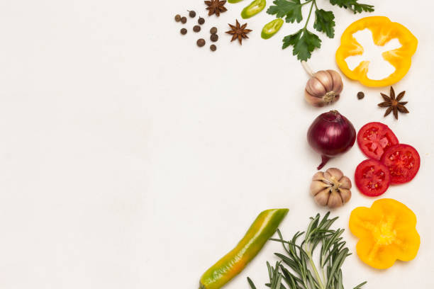 istock Spices on White background. Garlic and rosemary, peppers, tomatoes. 1286148567
