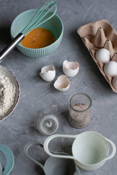 istock Pancake making process. Chef's workplace with cooking inventory and ingridients on a gray background. 1286149908