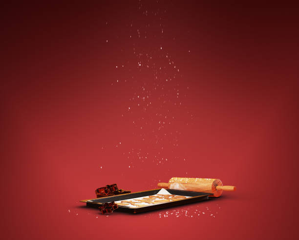 Gingerbread cookies and baking utensils with snow falling over it. Christmas baking concept with copy space.