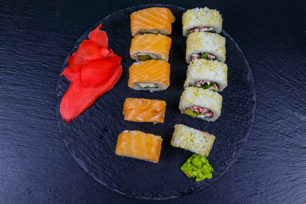 istock Set of sushi rolls on a black stone slate. Top view 1286151864