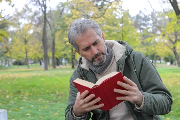 Photo of Senior man reading a book