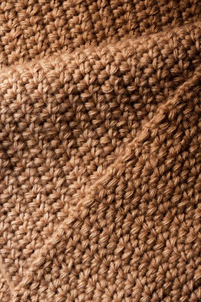 istock Brown knitted fabric close up 1286154579