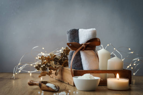 istock Two rolled up towels and wellness items on a rustic wood table 1286154837