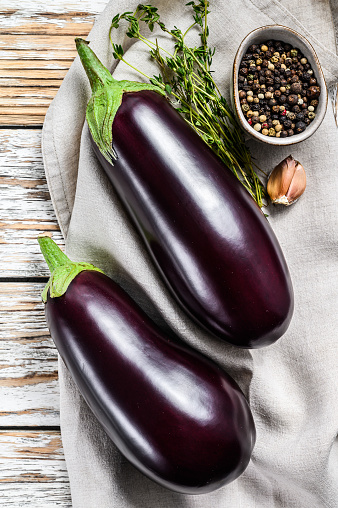 Raw purple eggplant. Organic vegetables. White background. Top view.