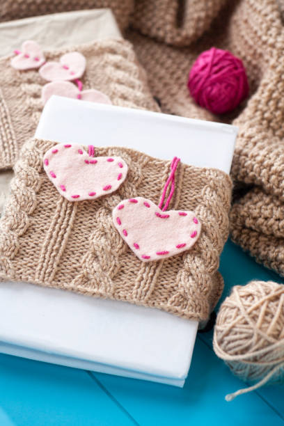 istock One old notebook in knitted cover with felt hearts 1286156115