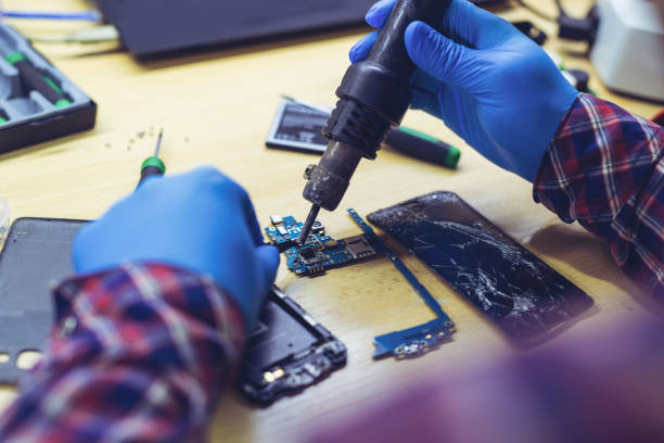 istock Technician Worker Soldering Elements and Repairing Smart Phone 1286156270