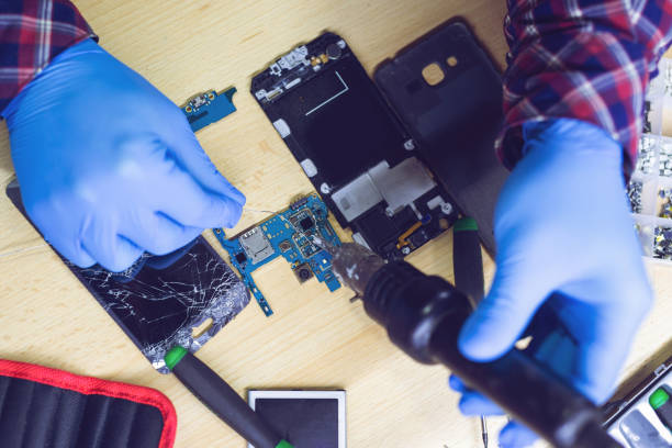 istock Technician Worker Soldering Elements and Repairing Smart Phone 1286156299