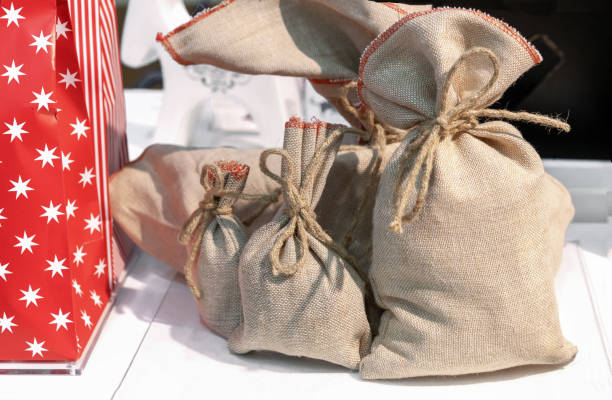 Burlap bags with drawstring for wrapping Christmas gifts.